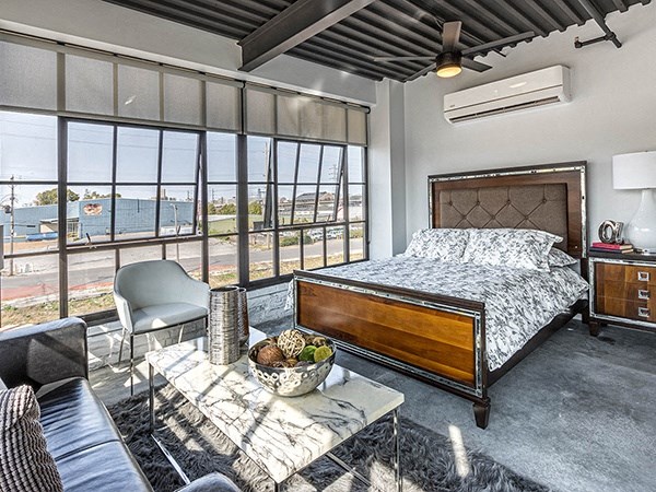 Steelcote Crossing bedroom area with concrete flooring and oversized windows at Steelcote Square, St. Louis, Missouri