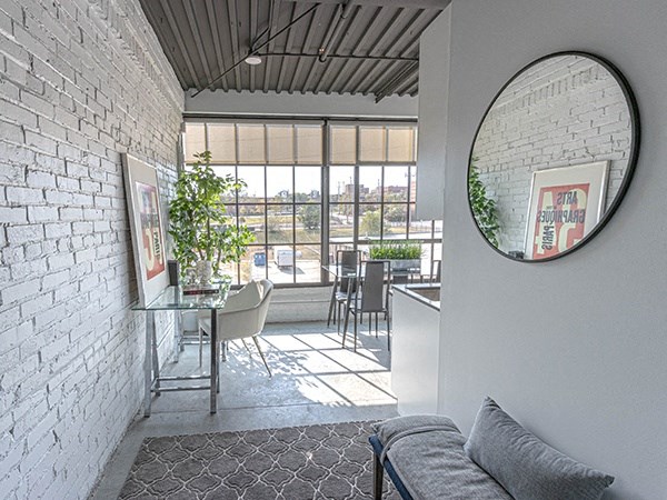 Steelcote Crossing entry way with exposed white brick wall, oversized windows and concrete flooring at Steelcote Square, Missouri, 63103