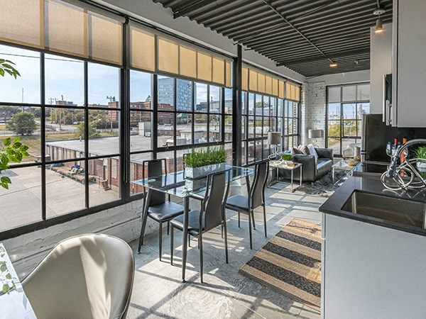 Steelcote Crossing living area with dinning room table and oversized windows at Steelcote Square, St. Louis