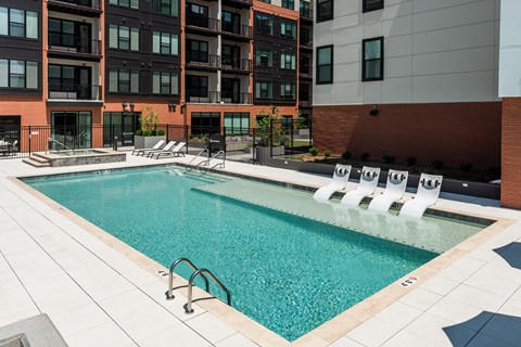 Sparkling pool with sun tanning ledge and hot tub  at Chapter at the Streets of St Charles, Saint Charles, MO