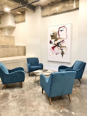 a group of blue chairs and a table in a room