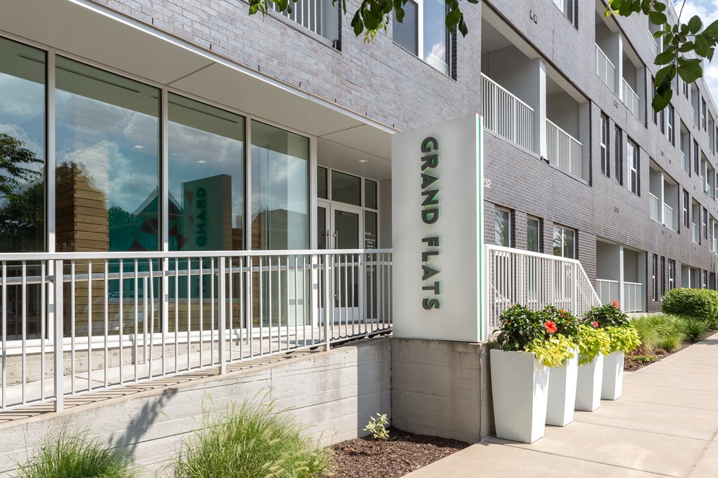 an office building with a large sign on the side of it at Grand Flats, St. Louis