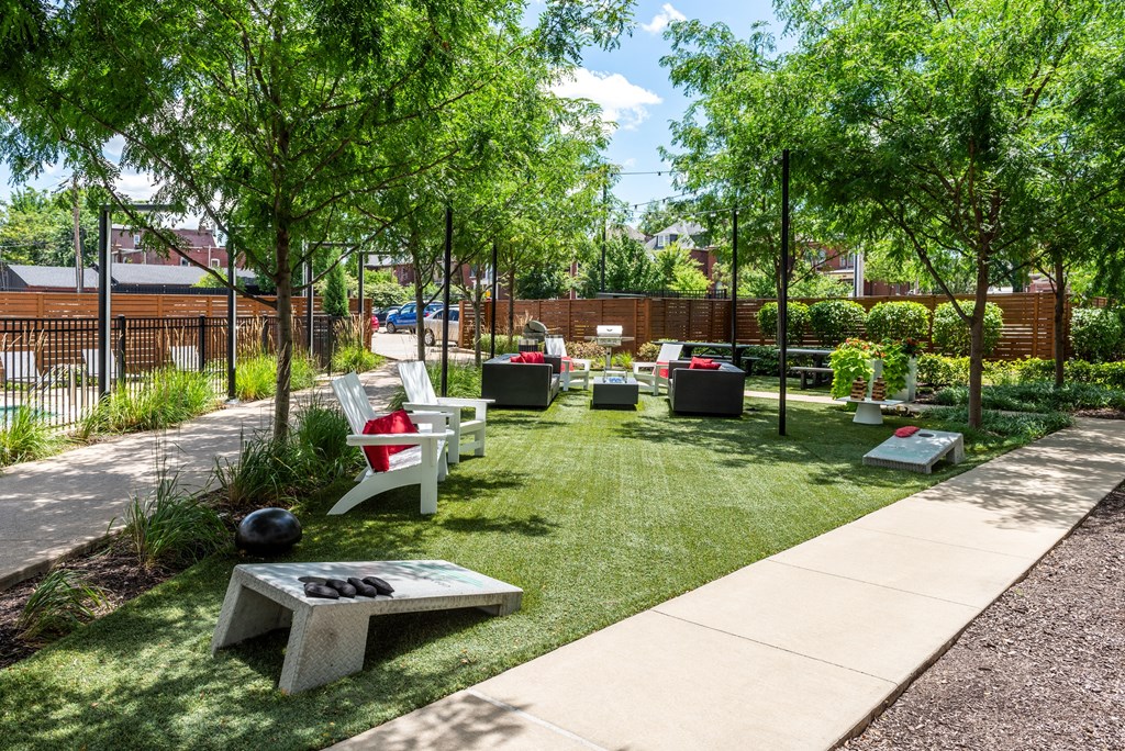 a courtyard with benches and grass and trees at Grand Flats, Missouri