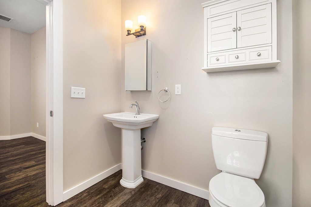 A white sink and toilet in a small bathroom.