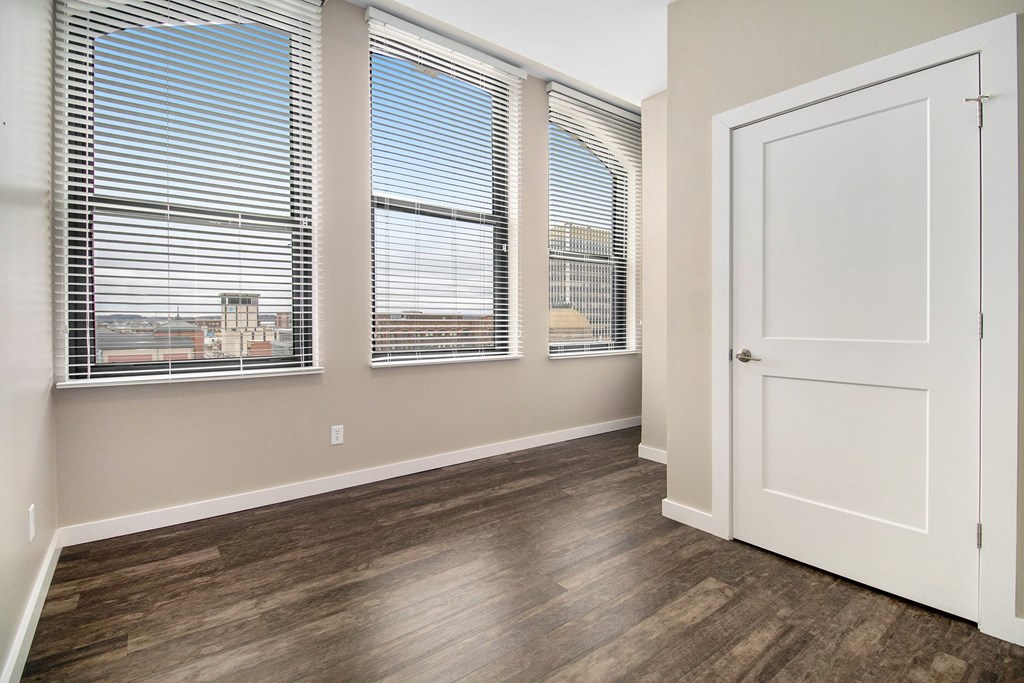 A room with a wooden floor and a white door.