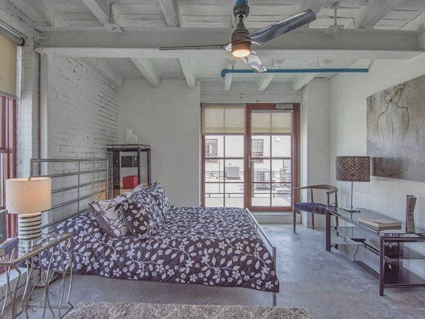 Steelcote Lofts bedroom with polished concrete floors, high ceilings and ceiling fan at Steelcote Square, St. Louis