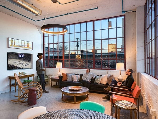 Steelcote Lofts clubroom with conversational seating, TV and oversized windows  at Steelcote Square, St. Louis, MO
