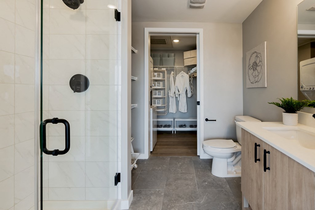 a bathroom with a shower and a sink and a toilet at One Foundry Way, St. Louis, 63110