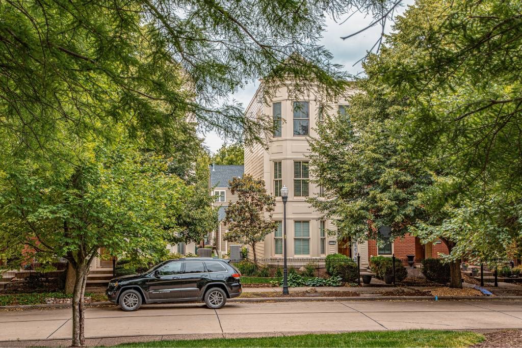 A black car is parked on the side of a street.