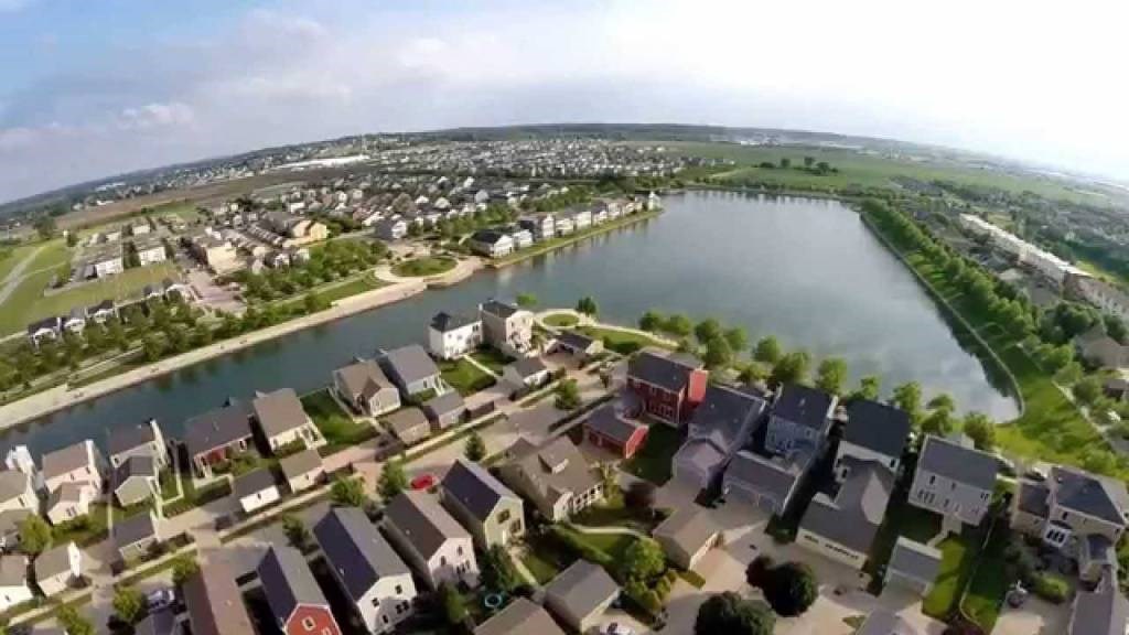 A bird's eye view of a residential area with houses and a river.