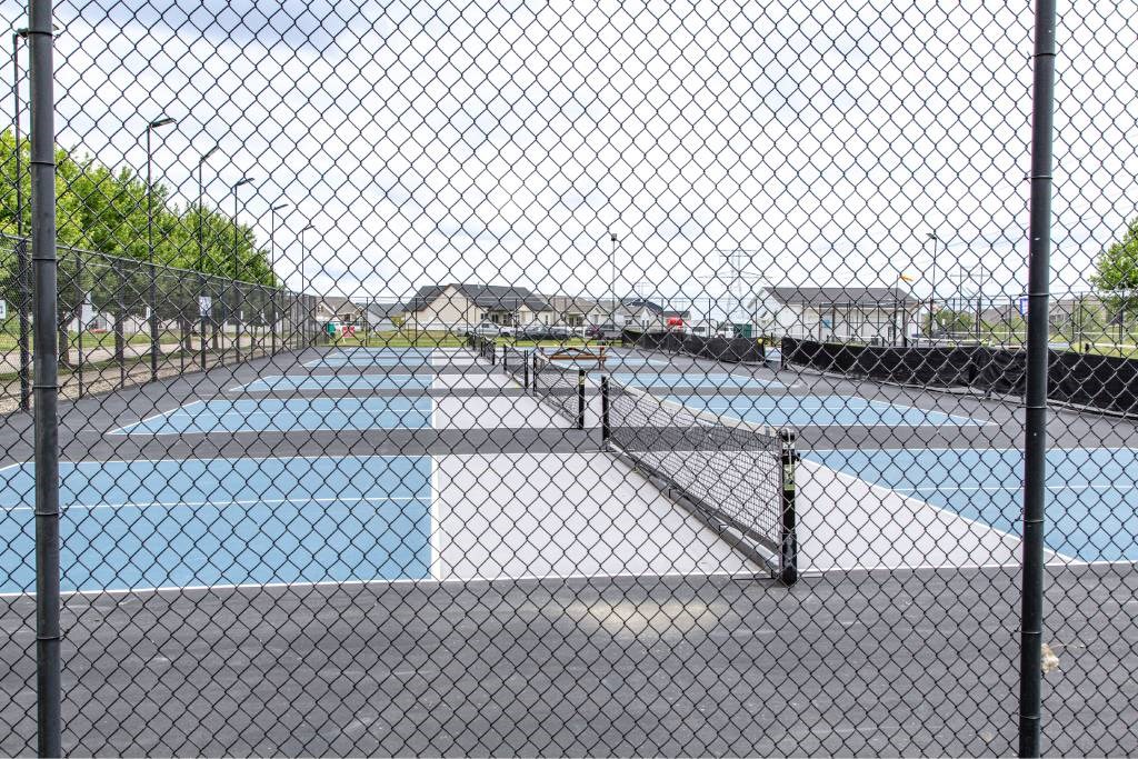 A chain link fence surrounds a pool.