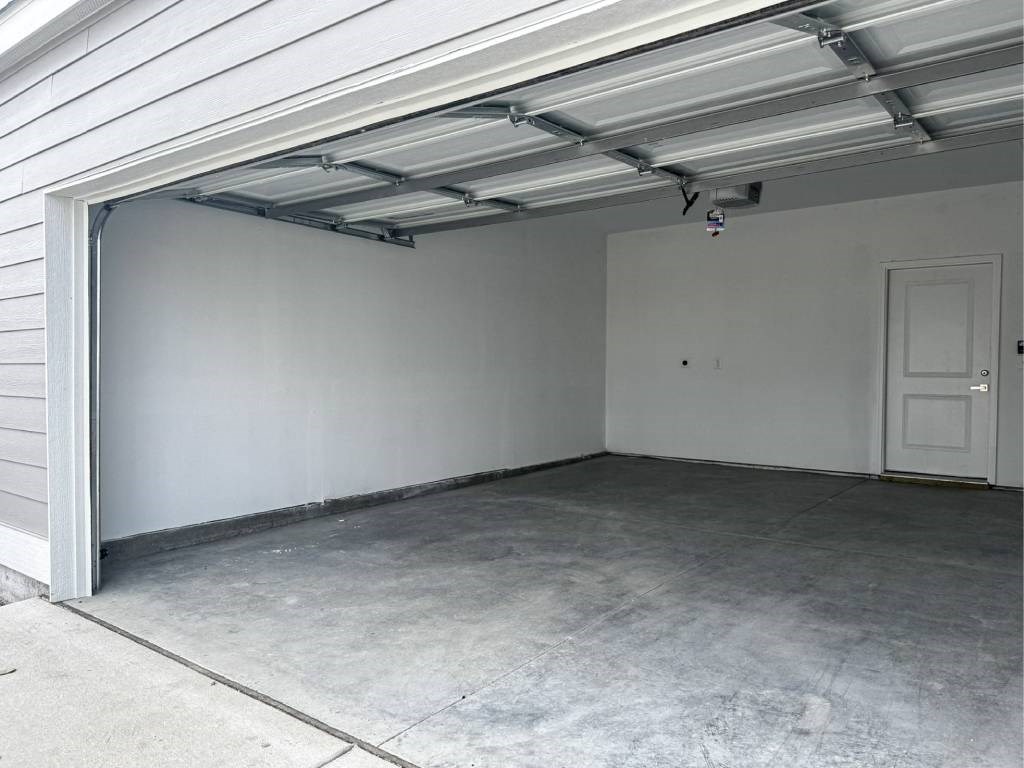 A white garage door is open.