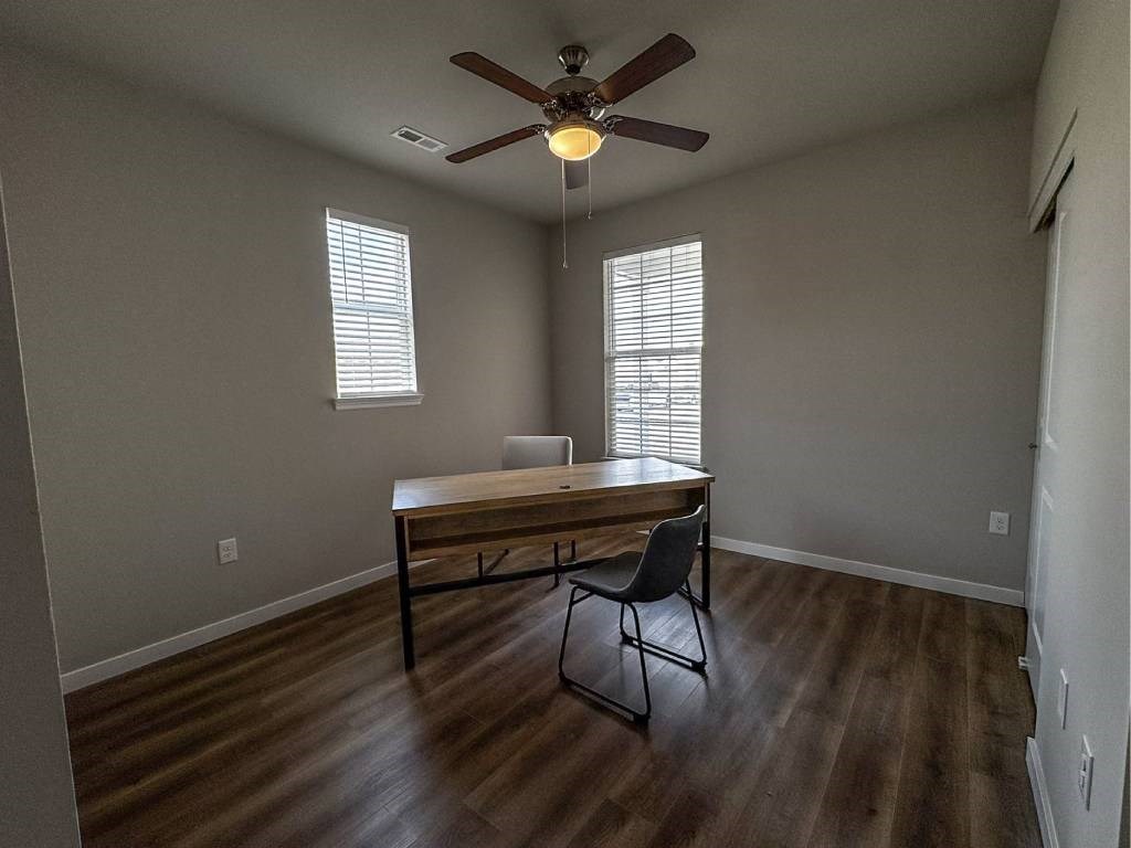 A room with a table and a chair in it.