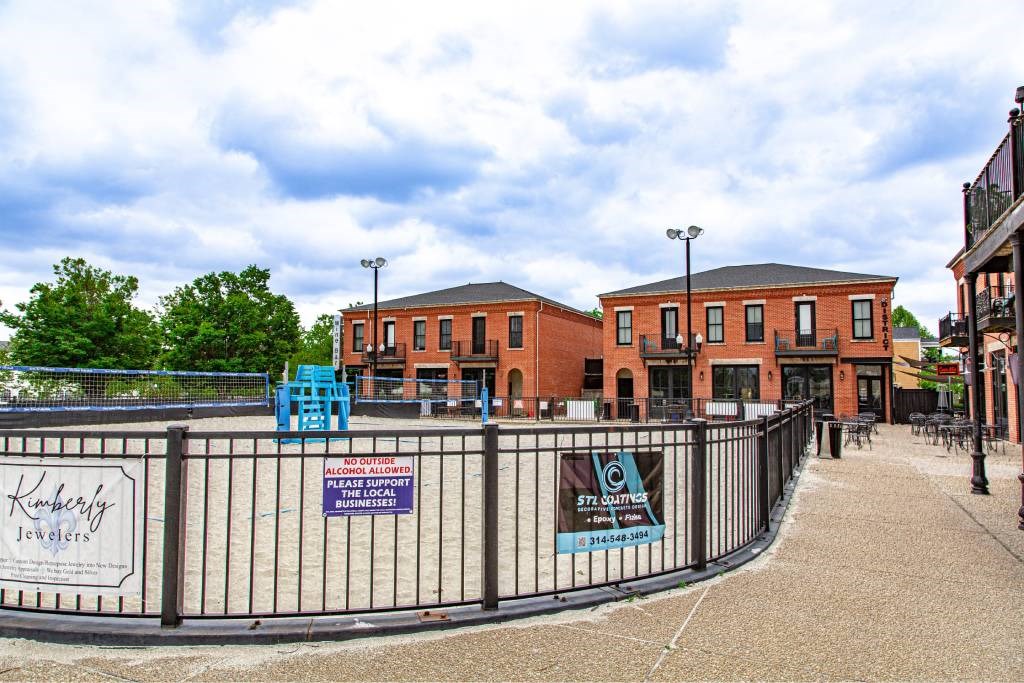 A fenced area with a sign that says "Please support burgers".