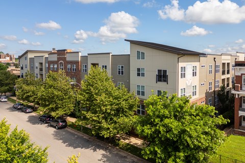 A row of townhouses with trees in front of them.