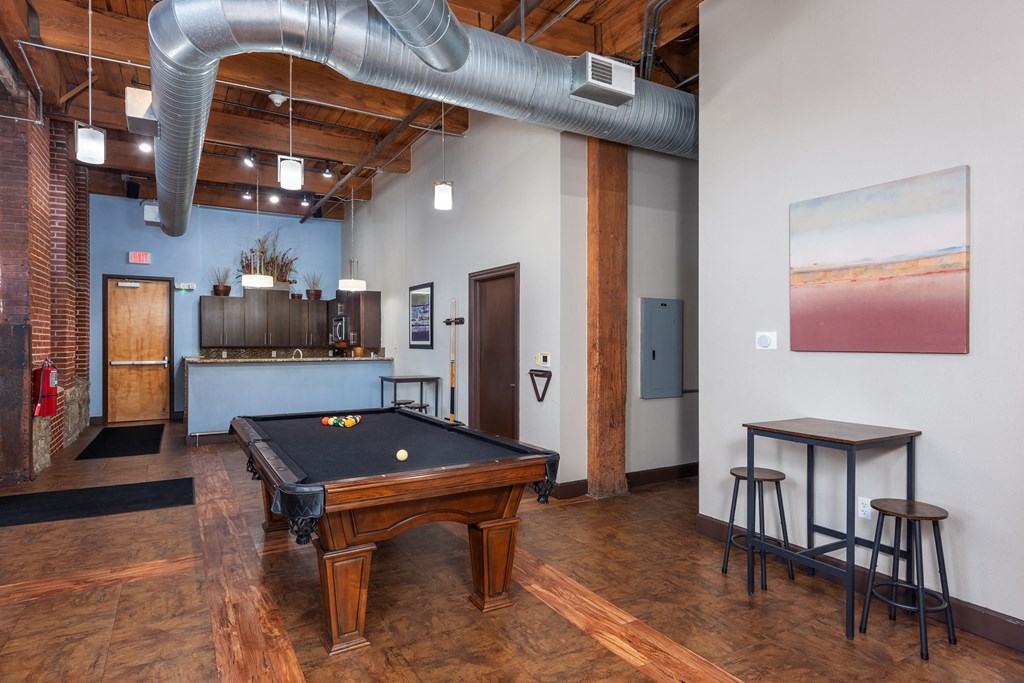 A room with a pool table and a bar at Lofts at Lafayette Square Apartments, Missouri