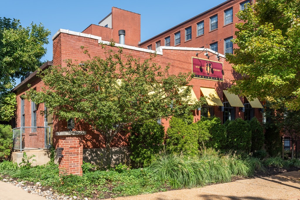 A red brick building with a sign at Lofts at Lafayette Square Apartments, Saint Louis