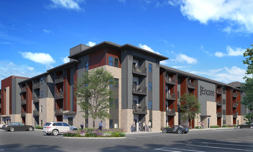 A modern apartment complex with the name "E'ncore" on the side of the building.