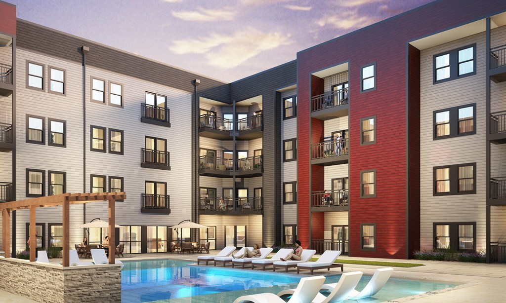 A modern apartment complex with a pool in the foreground.