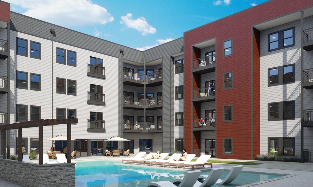 A modern apartment complex with a pool in the courtyard.