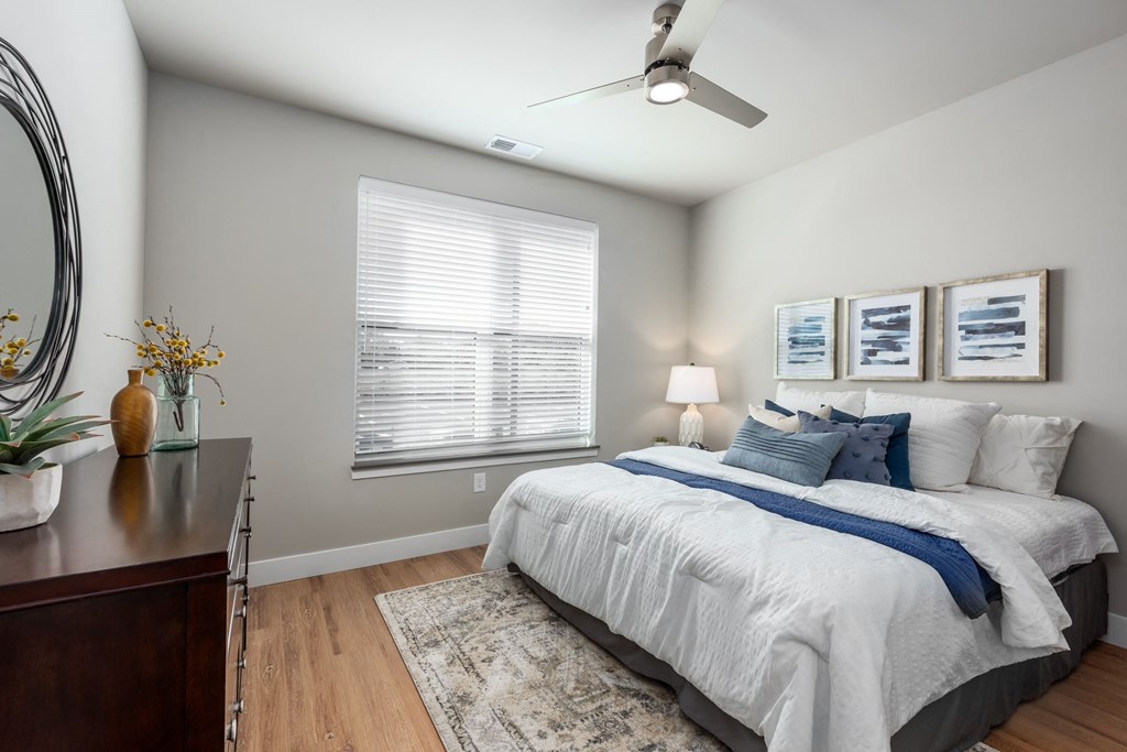 a bedroom with a large bed and a ceiling fan