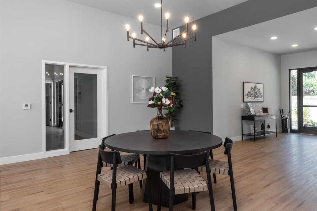 a dining room with a table and chairs and a chandelier