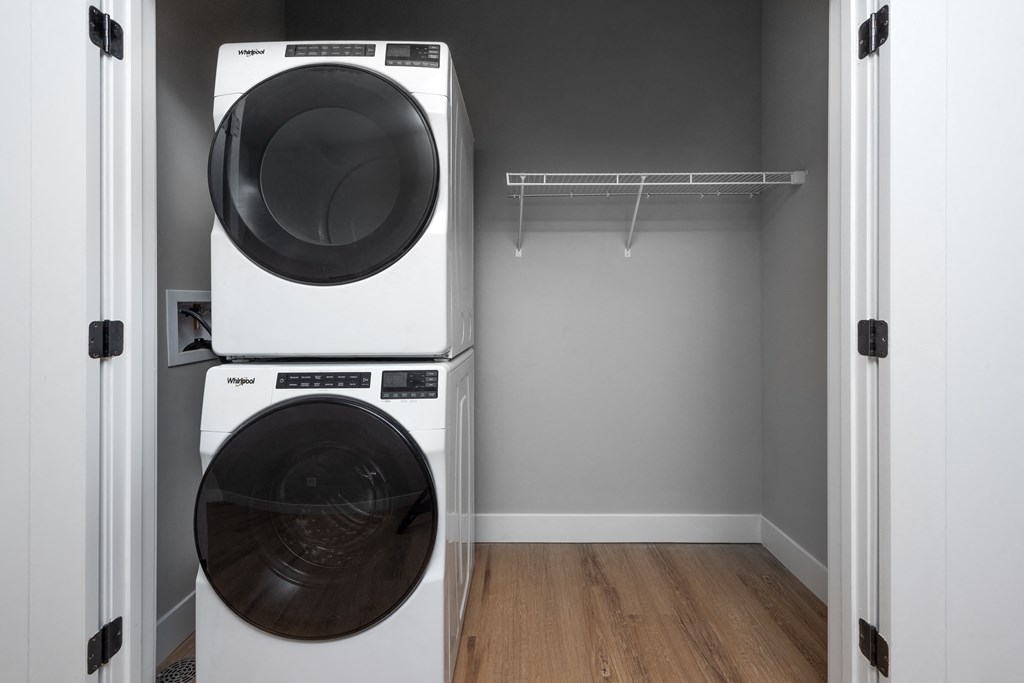 a washer and a dryer in a room with a closet