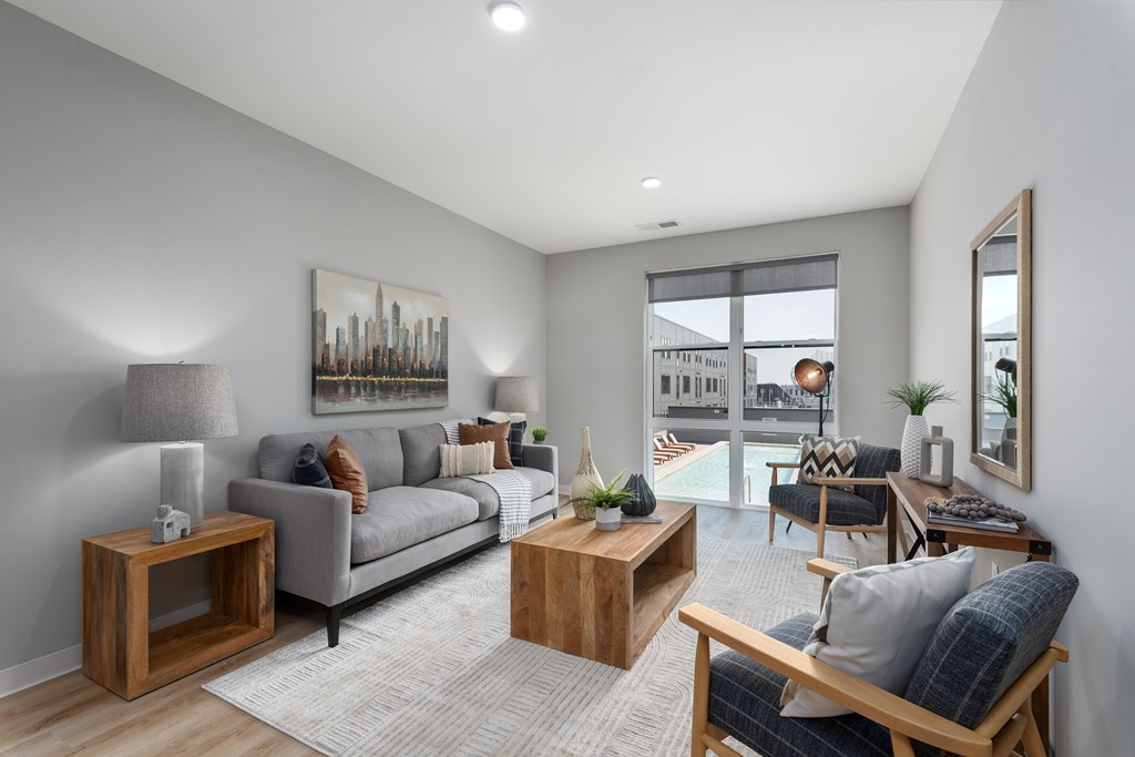 an open living room with a couch and a table    and a patio at The Edwin on Grand Apartments, St Louis, MO, 63103