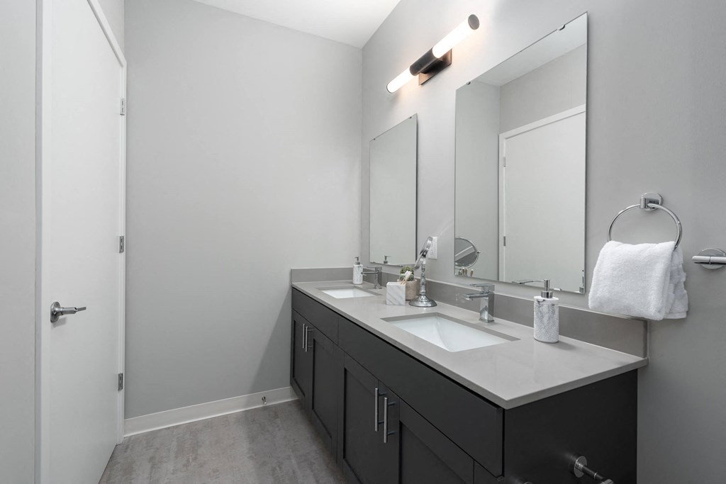 an empty bathroom with a sink and a mirror at The Edwin on Grand Apartments, St Louis, 63103