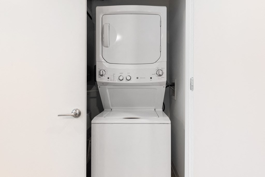 an empty laundry room with a washer and dryer at The Edwin on Grand Apartments, Missouri, 63103