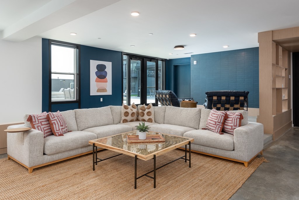 a living room with a couch and a coffee table at The Edwin on Grand Apartments, St Louis, 63103