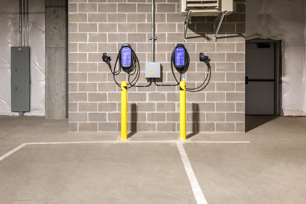 a parking meter in front of a brick wall at The Edwin on Grand Apartments, St Louis, MO