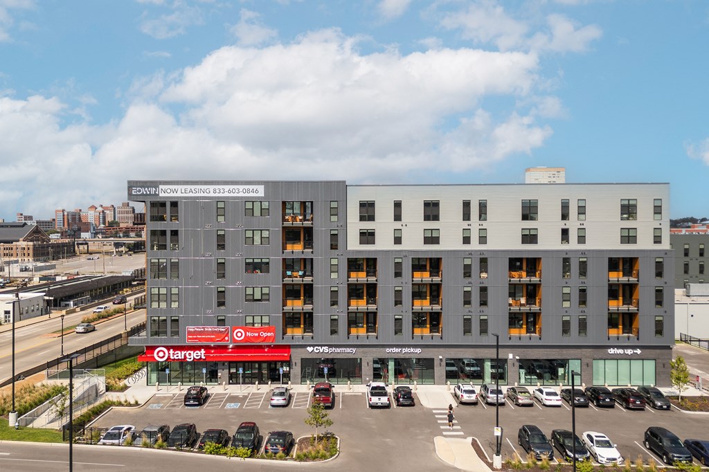 a large apartment building with cars parked in front of it at The Edwin on Grand Apartments, Missouri, 63103