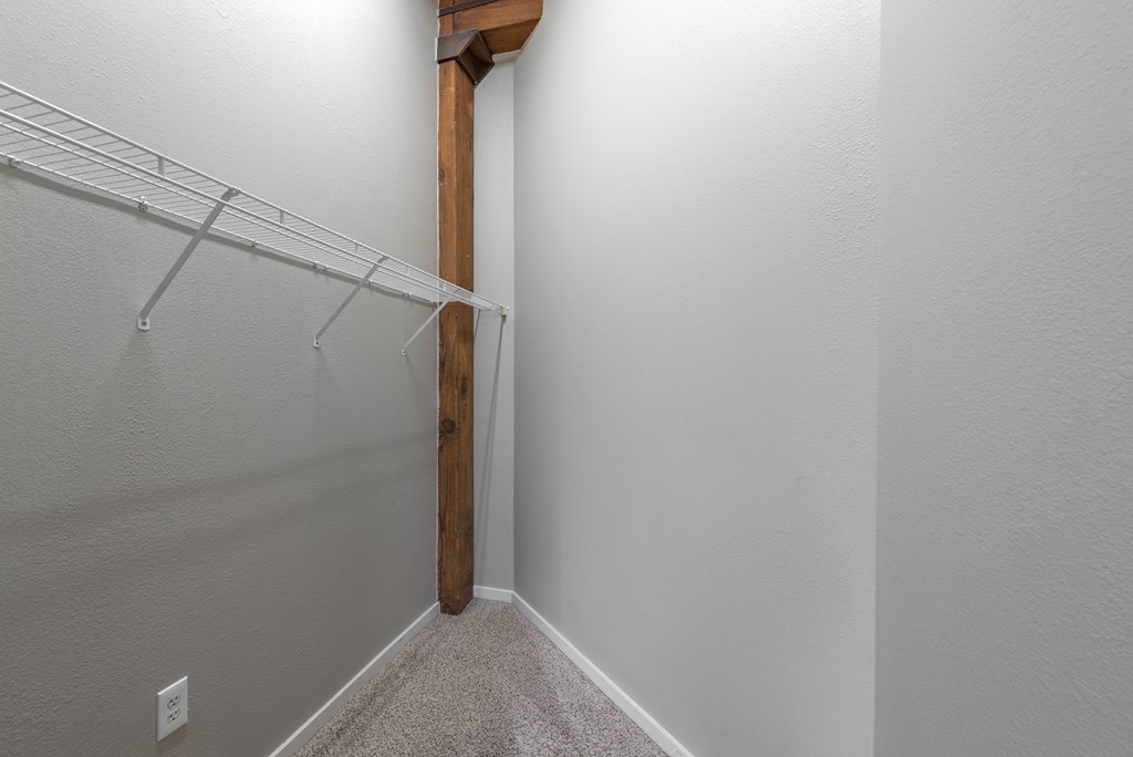 a spacious closet in a bedroom with a mirrored closet door at Lofts at Lafayette Square Apartments, Saint Louis, MO