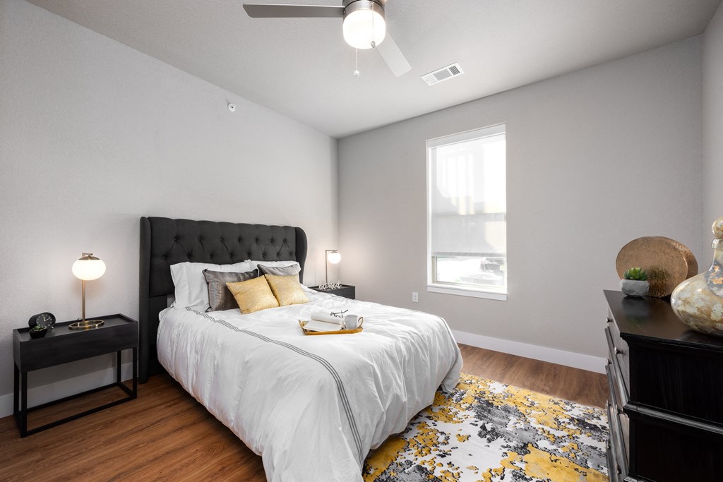 a bedroom with a large bed and a window at The Station St. Peters, Missouri, 63376