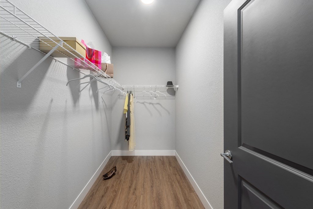the closeness of the closet in a bedroom with a door to the bathroom at The Station St. Peters, Missouri