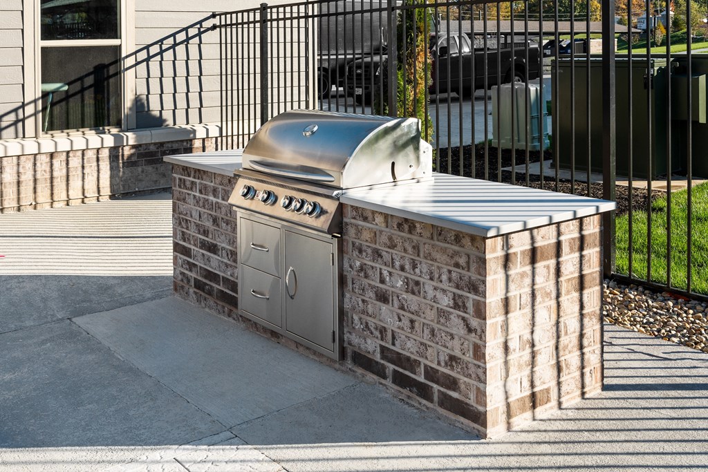 a stainless steel barbecue grill in front of a house at The Station St. Peters, St. Peters, MO 63376