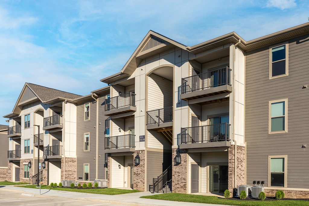 a row of apartment buildings with balconies and stairs at The Station St. Peters, St. Peters, MO