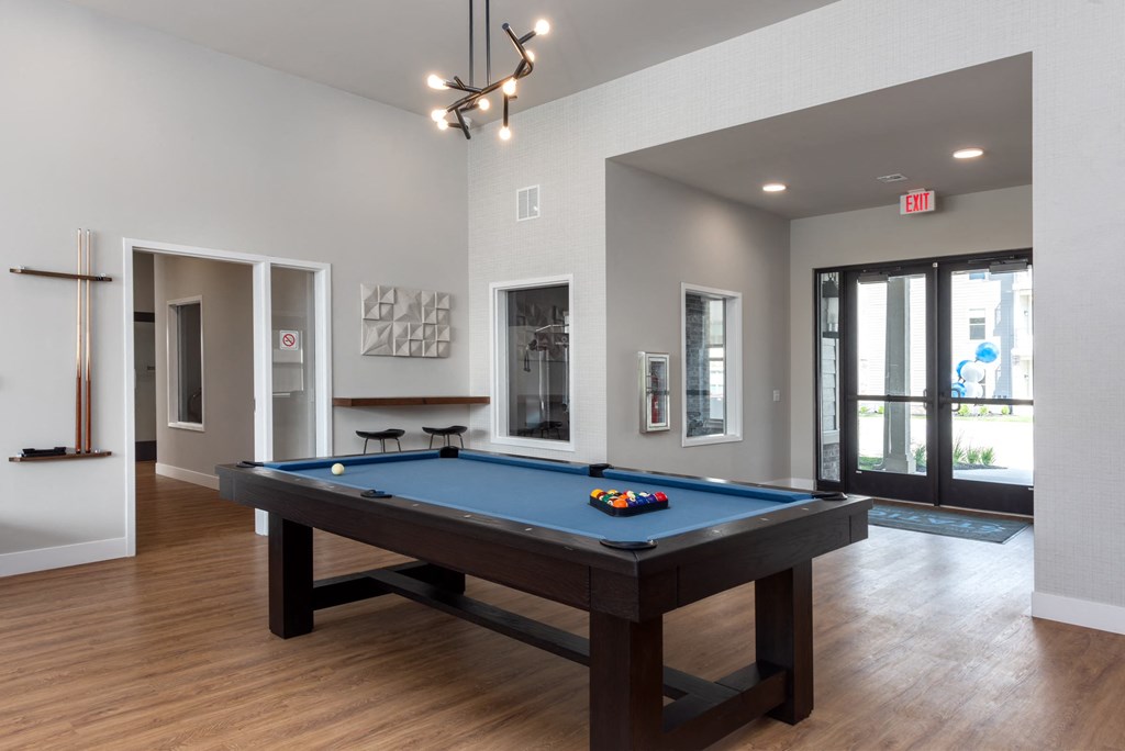 a pool table in the clubhouse of a new home at The Station St. Peters, Missouri, 63376