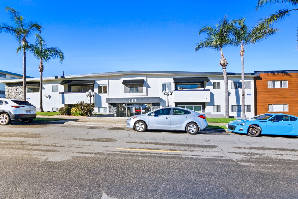a large building with cars parked in front of it