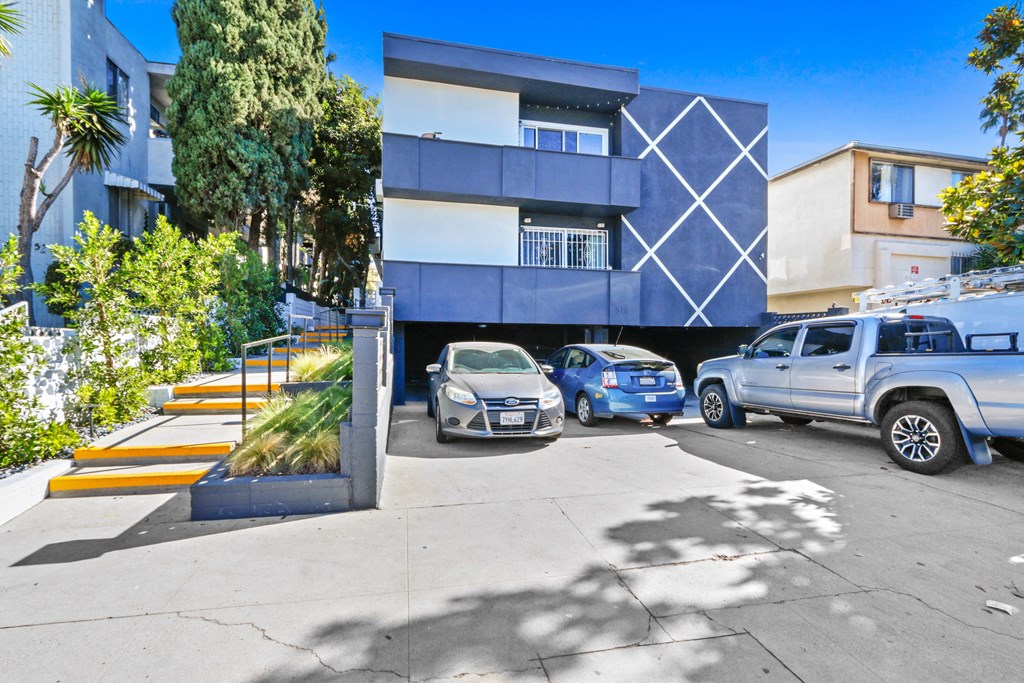 a blue and white building with cars parked in front of it