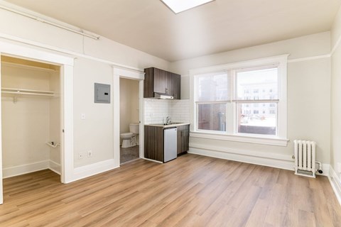 A room with a window and a radiator on the wall.