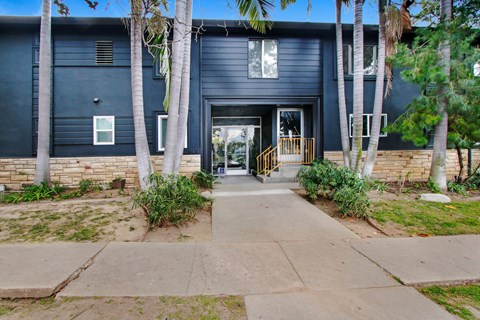 A black building with a white door and windows.
