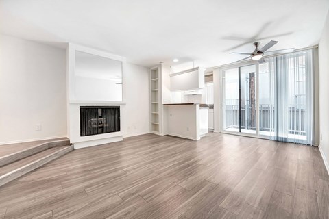 A spacious living room with a fireplace and sliding glass doors.