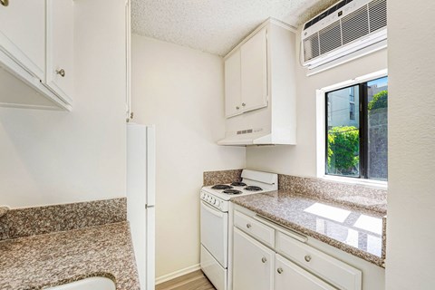 A small kitchen with a stove and a window.