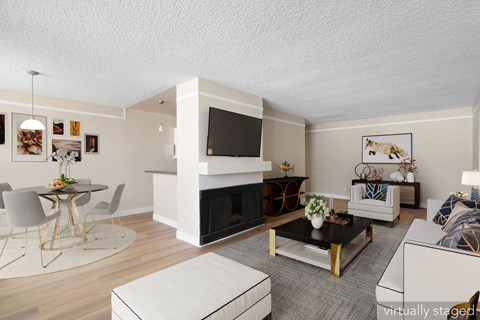 A living room with a fireplace and a television.