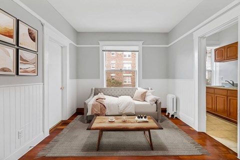 A cozy bedroom with a large bed and a window overlooking a city street.