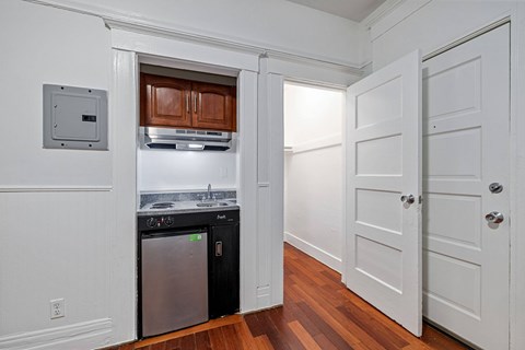 A kitchen with a dishwasher and a refrigerator.