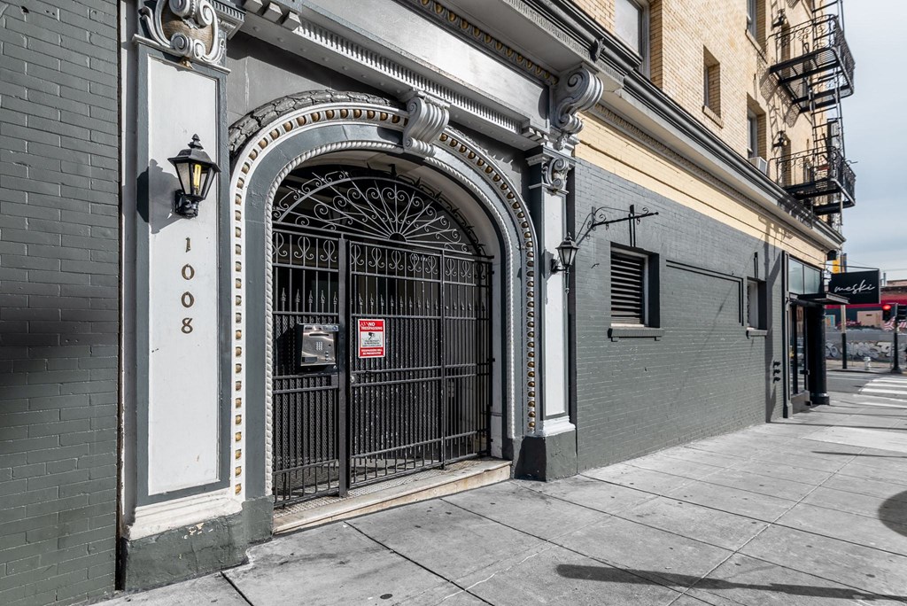 A building with a black gate and a sign that says 1008.