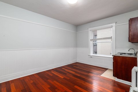 A room with wooden floors and white walls.